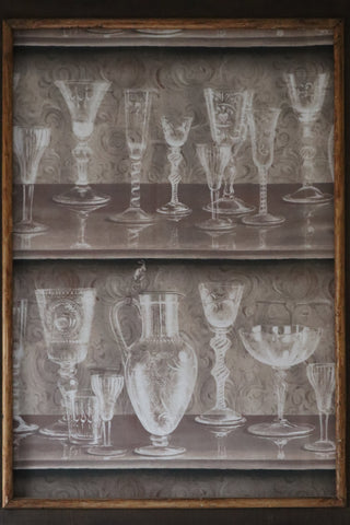 Framed textile art with Pierre Frey Boheme Taupe fabric showing antique glassware