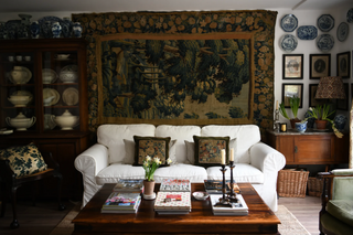 world of interiors magazine article cover living room with white sofa and 17th century tapestry