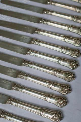 Antique French silver cheese knives with ornate handles and silver blades