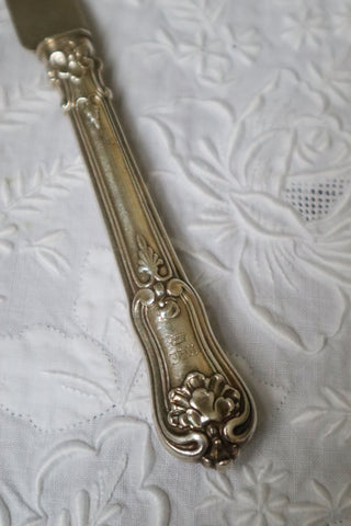 Engraved FM initials and crown motif on Minerva silver knife handles