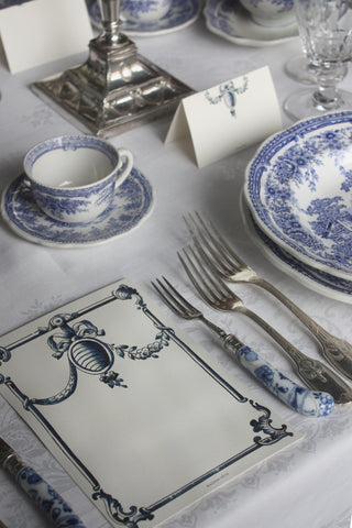 Delft-inspired antique menu cards with blue and white tile motif