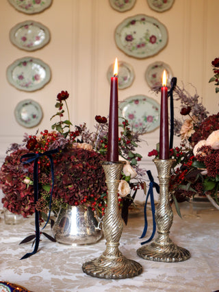 Mercury-glass effect candlesticks on a floral holiday tablescape