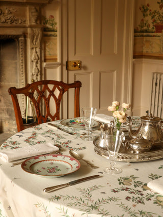 Antique compaigns des indes porcelain plates and soup bowls on a patterned tablecloth