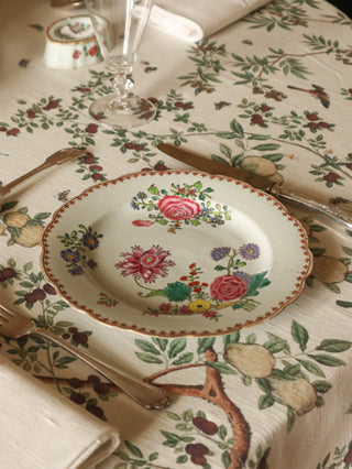 18th-century hand-painted porcelain plate with scalloped edge and floral design
