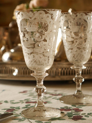 Pair of antique wine glasses with detailed etched scenes
