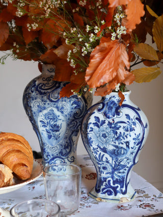 Antique blue and white Delft vases with bird motifs on decorative table