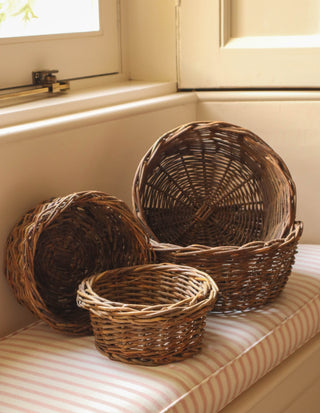 Set of four vintage round nesting baskets made from natural woven materials