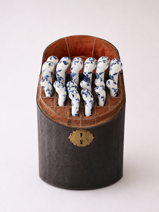 Complete set of 12 Worcester porcelain handled knives and forks in open fish-skin case
