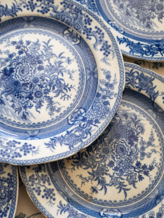 Chinoiserie transferware plate styled on a floral tablecloth with silver cutlery